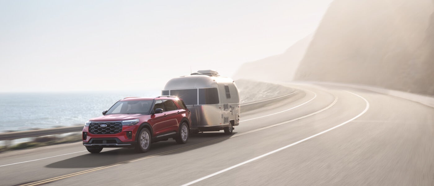 2026-Ford-Explorer-Exterior-Towing-Camper-On-Curved-Road